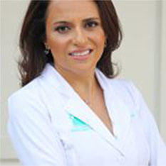 Dr. Orna Ourshalimi wearing a white coat, smiling